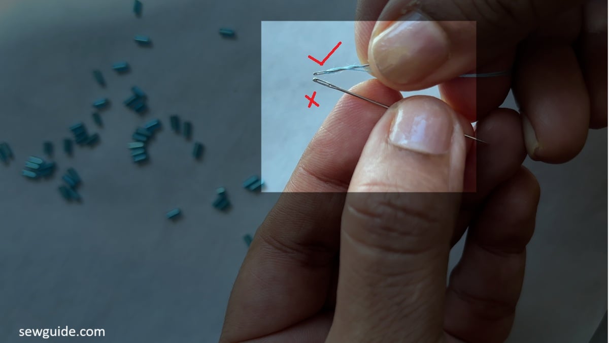 needle that would pass through the bugle bead and the one which would