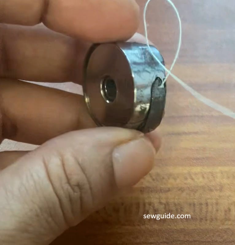 pull up the thread through the latch