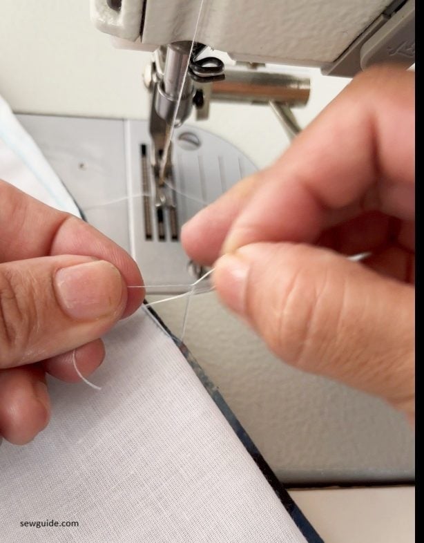 tying the thread tails