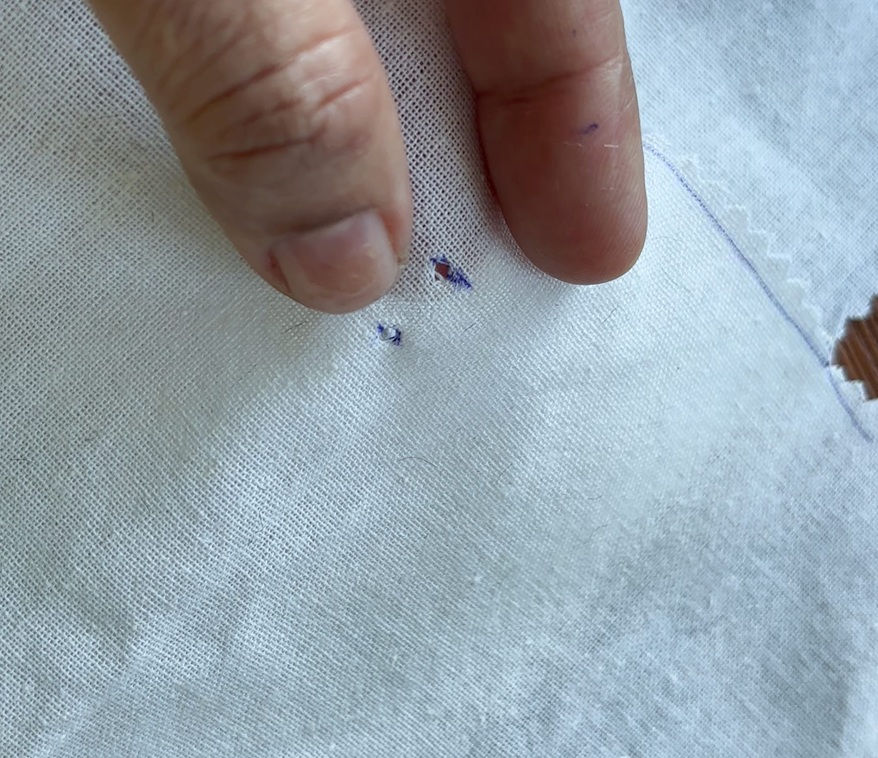 marks and hole for inserting the legs of the magnetic snaps