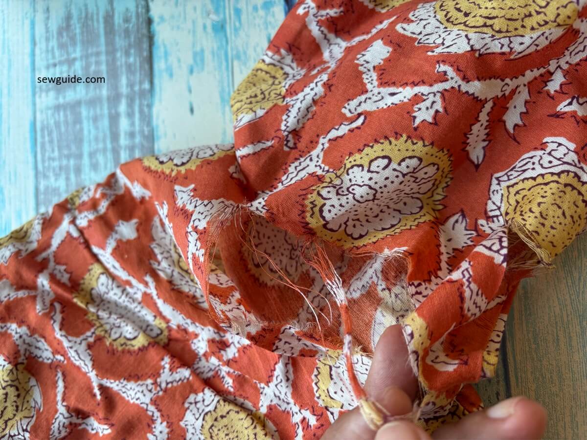 fabric ripped along the arm on a garment