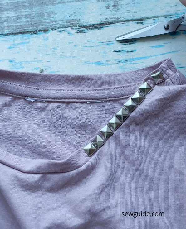 studs attached to the neckline 