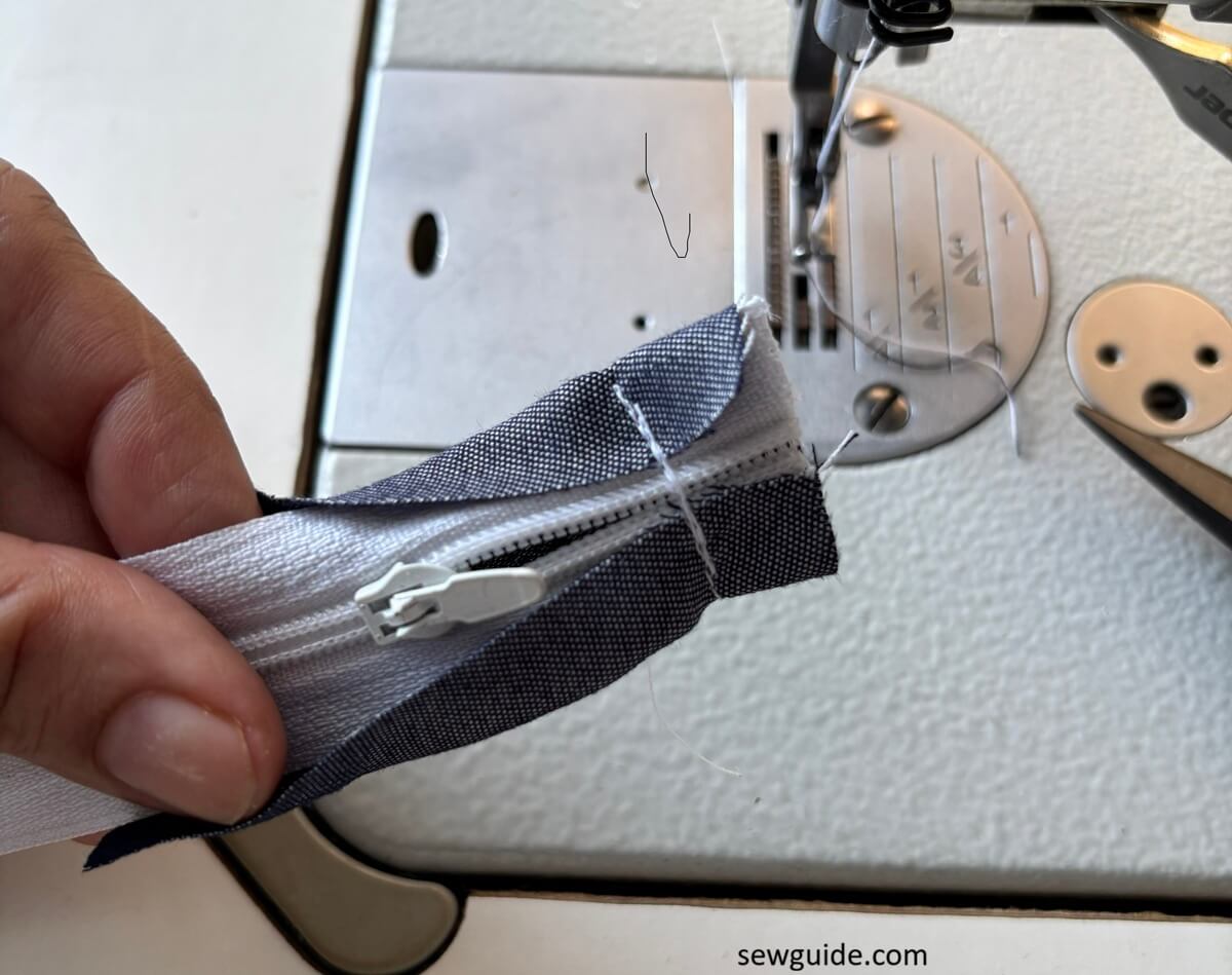 stitching across the zipper teeth
