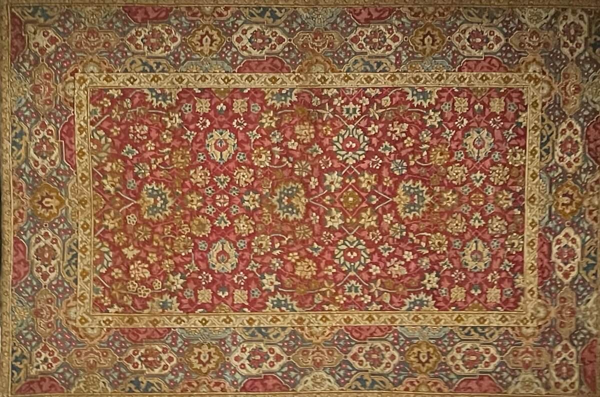 Textile displayed on the wall of a museum